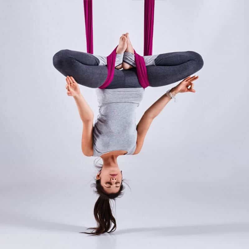 Woman Sitting on a Yoga Mat Near an Aerial Yoga Swing · Free Stock Photo